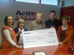Members of Agherton parish's 303 Youth Club present a cheque to Action Cancer.